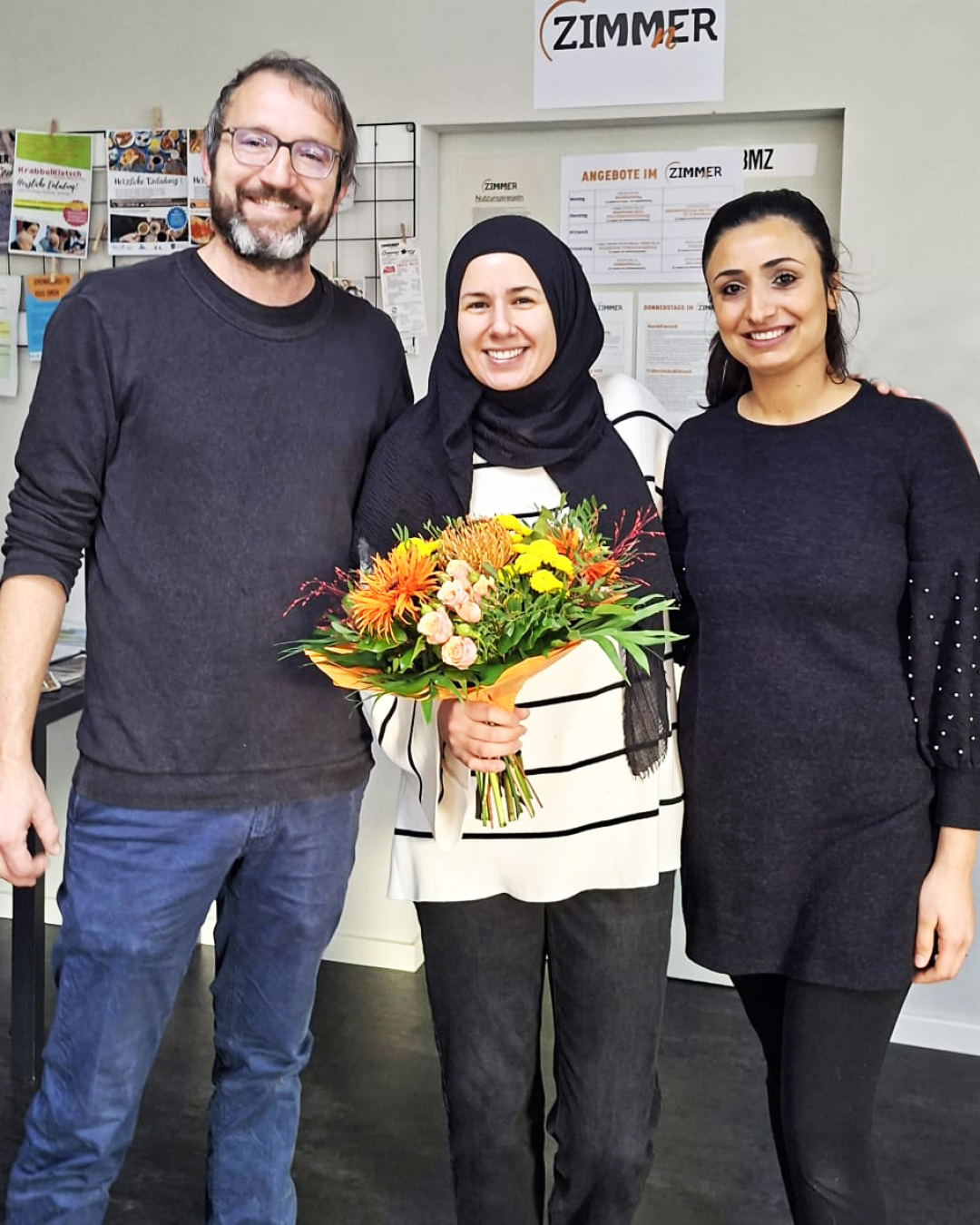 Im Foto Martin Grundl, Özge Gökce mit Blumenstrauß und Fatma Temel